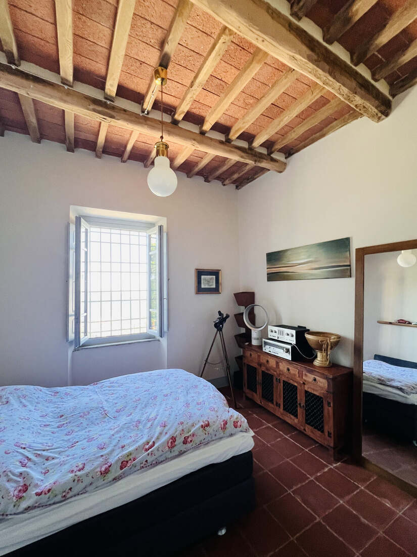 Bedroom with wooden beam ceiling